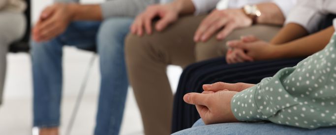 A shot of people's hands while sat in a cocaine rehab group therapy session - Step by Step Recovery