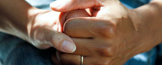 Two women holding hands in a supportive way during drug detox - Step By Step Recovery